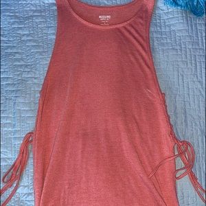 coral colored tank-top with cross ties on the side